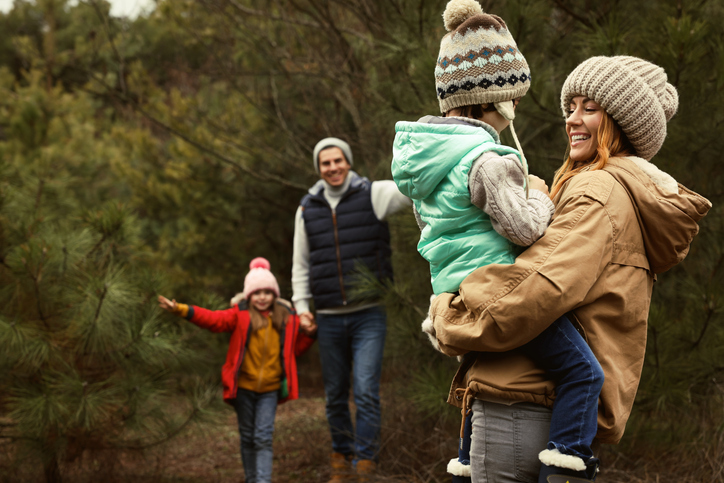 Happy family spending time together in forest