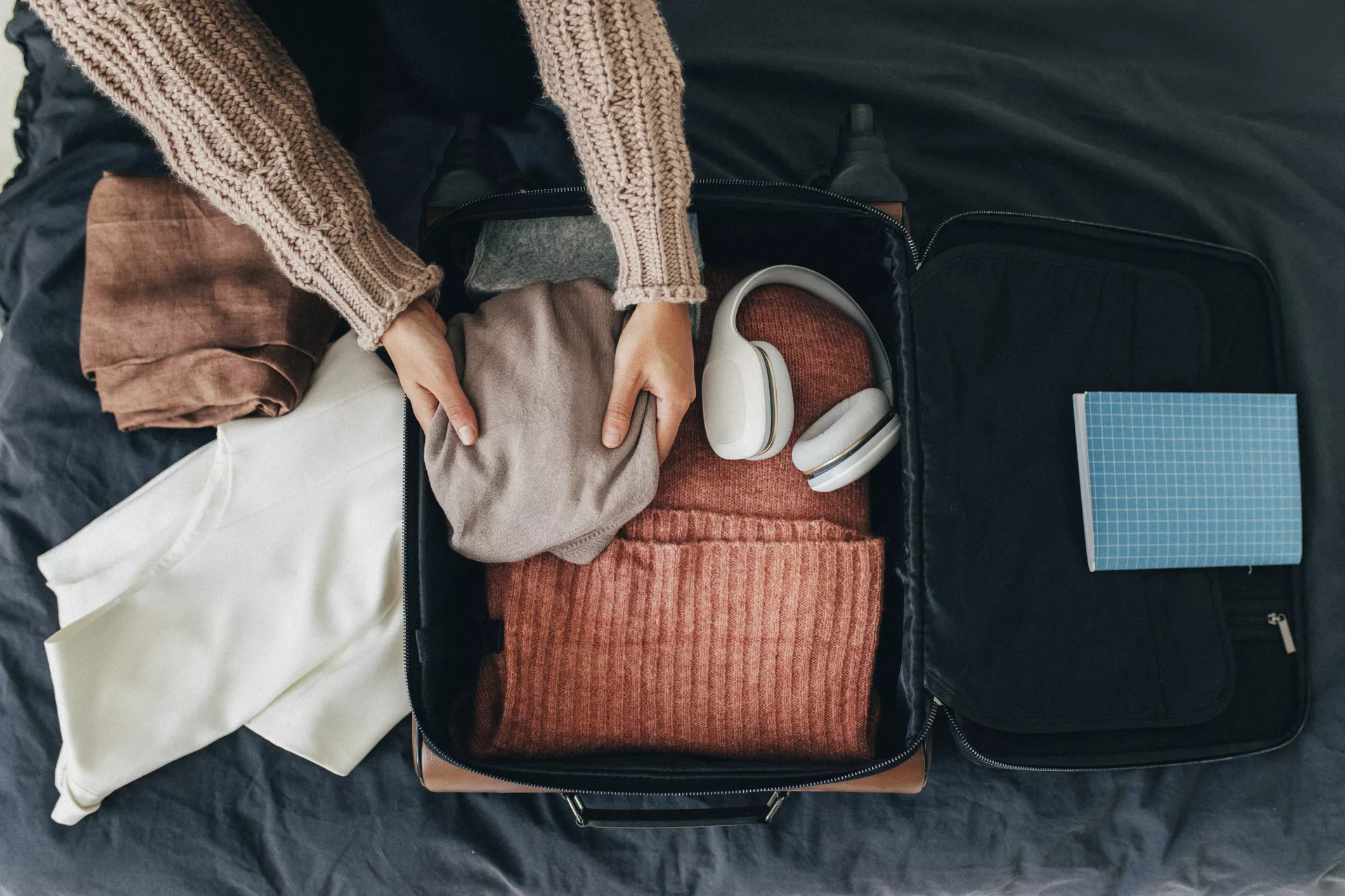 Woman Packing her Suitcase for Winter Holiday